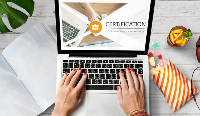 A man searching for what is cmmc certification on a laptop