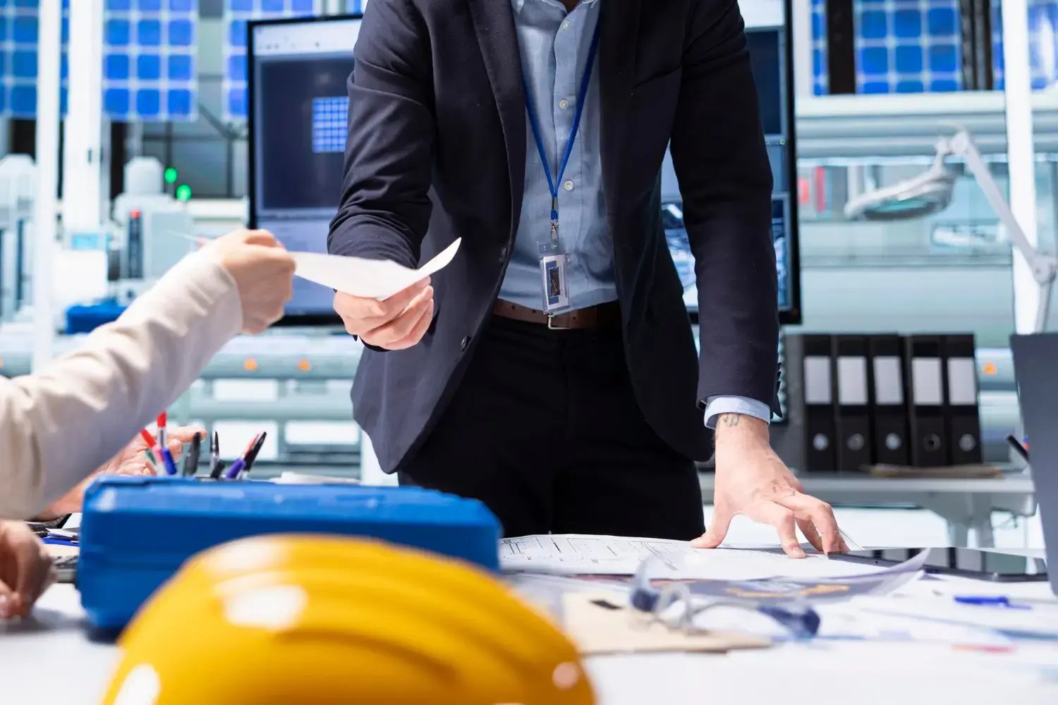an-IT-specialist-for-it-solutions-for-construction-industry-with-a-hard-hat-on-a-table